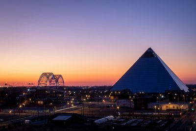 The Memphis Pyramid and Hernando de Soto Bridge at sunset in Memphis, TN.
