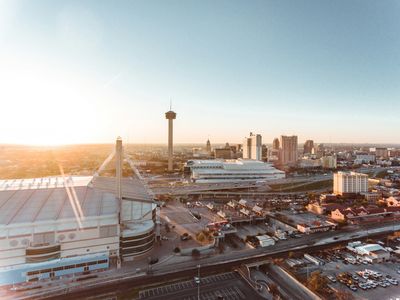 The Tower of the Americas and the Alamodome in San Antonio, TX at sunset.